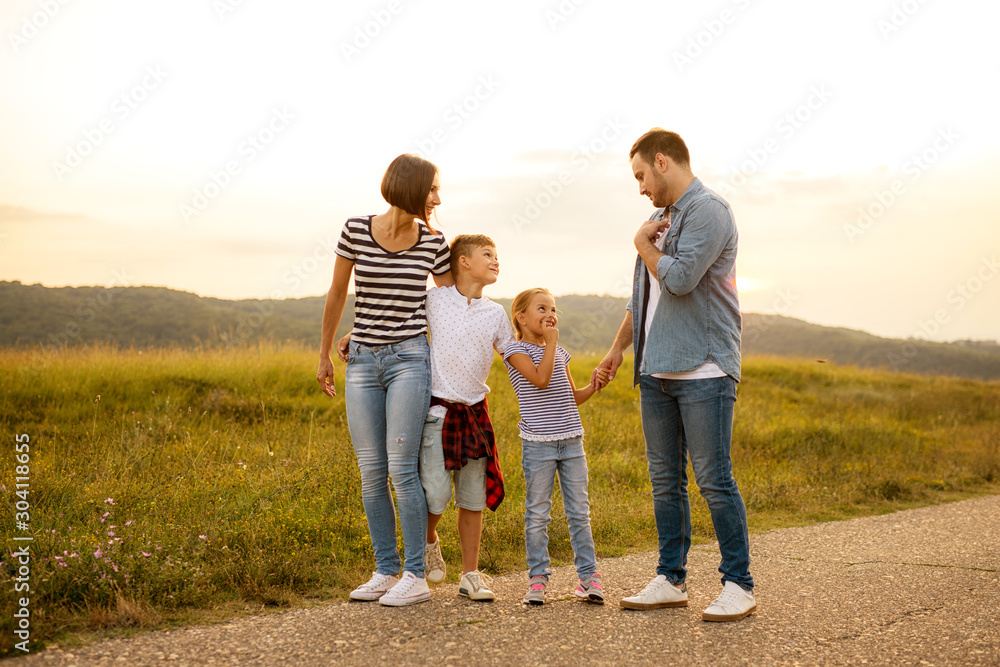 Shot of a family of four enjoying a sunny day in the nature Shot of a family of four enjoying a sunny day in the nature