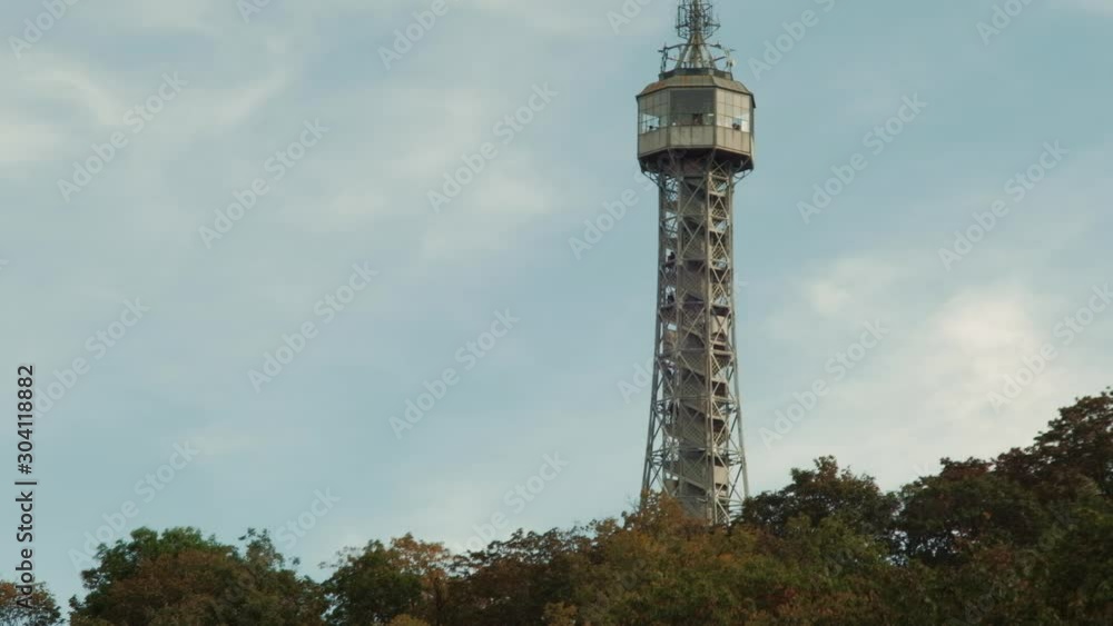 Prague, Czech Republic - September 2019: View of hill with Petrin Lookout Tower and fast moving clouds in background. 4K resolution speed up. Prague, Czech Republic - September 2019: View of hill with Petrin Lookout Tower and fast moving clouds in background. 4K resolution speed up.