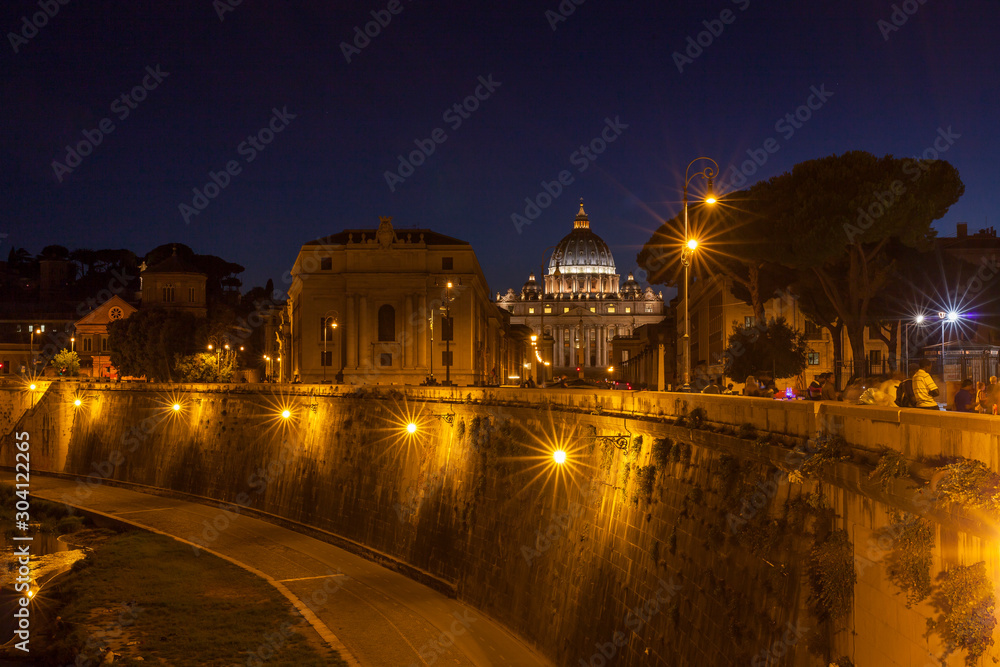 Roma by night with St. Peter Church far behind.