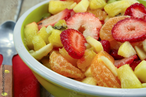 plate of fresh fruit salad on a wooden table
