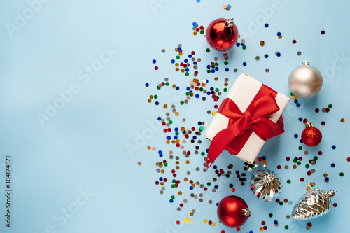 Christmas card, Christmas present with toys on a blue background, top view with place for congratulation