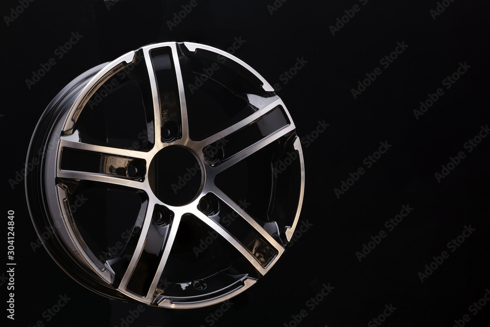 Obraz premium car cast aluminum alloy wheels, black silver with polished front, very beautiful and modern, fashion. Close-up on dark background, elements, spokes.