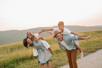 Happy smiling family spending summer day at park.