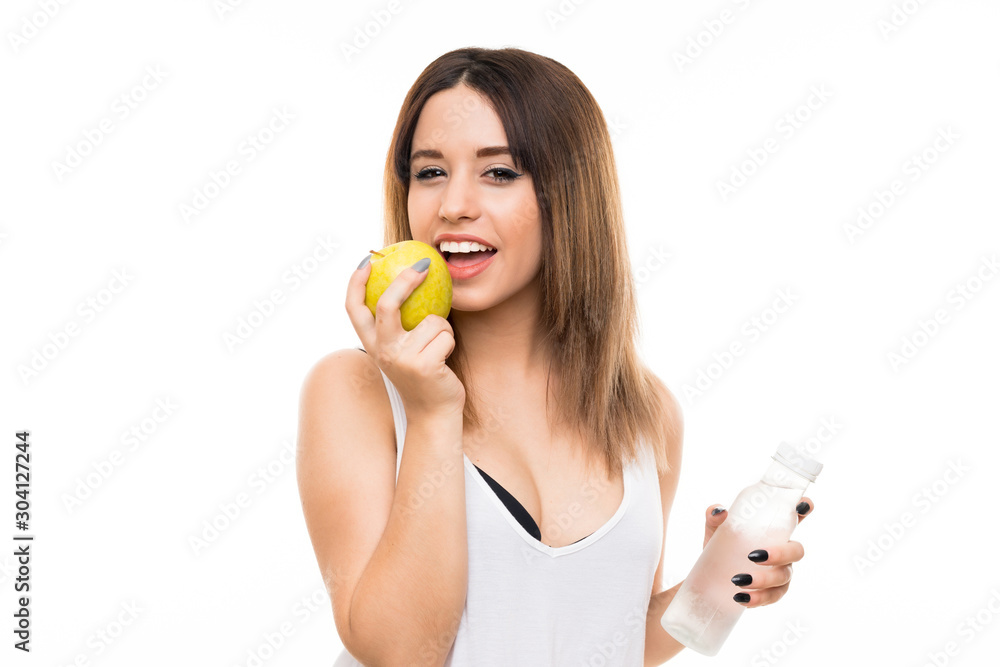 Young woman over isolated white background with an apple Young woman over isolated white background with an apple
