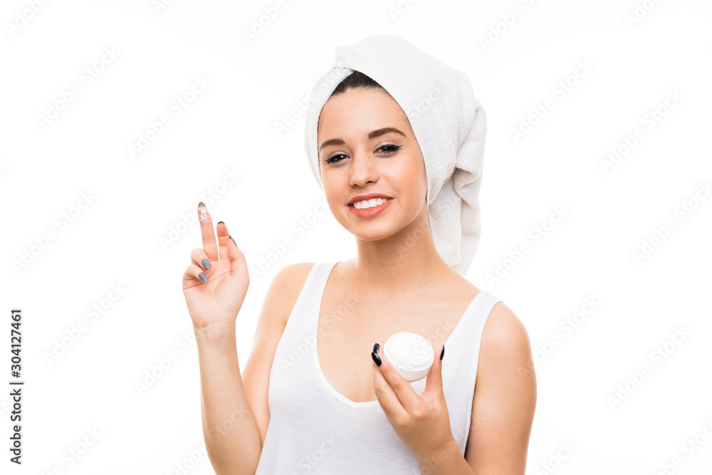 Young woman over isolated white background with moisturizer Young woman over isolated white background with moisturizer