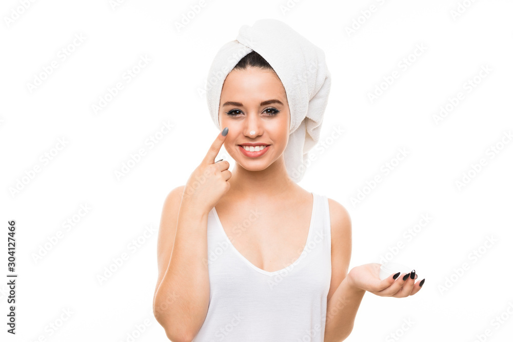 Young woman over isolated white background with moisturizer Young woman over isolated white background with moisturizer