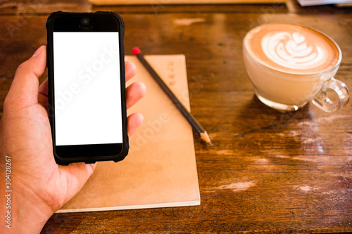 Close up of Hand man holding smart phone in Cafe blurred background