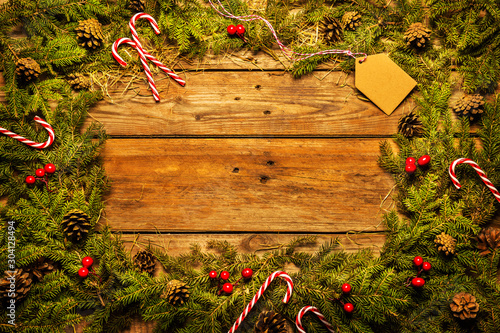 Christmas background - pine branches frame (border) on wood