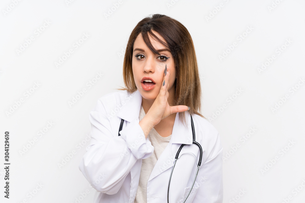 Young doctor woman over isolated background whispering something Young doctor woman over isolated background whispering something