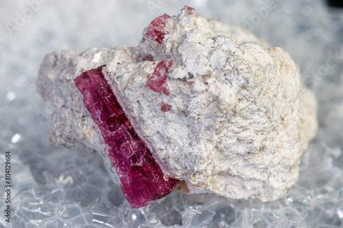 macro mineral stone red beryl on a black background photo