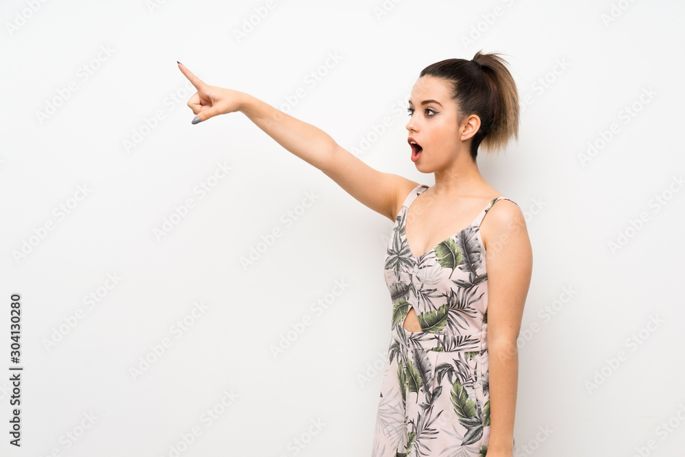 Young woman over isolated white background pointing away Young woman over isolated white background pointing away