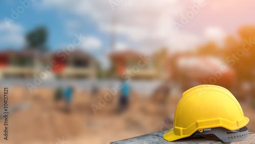 Fotografie, Obraz Construction safety concept, yellow hard safety helmet hat in construction site