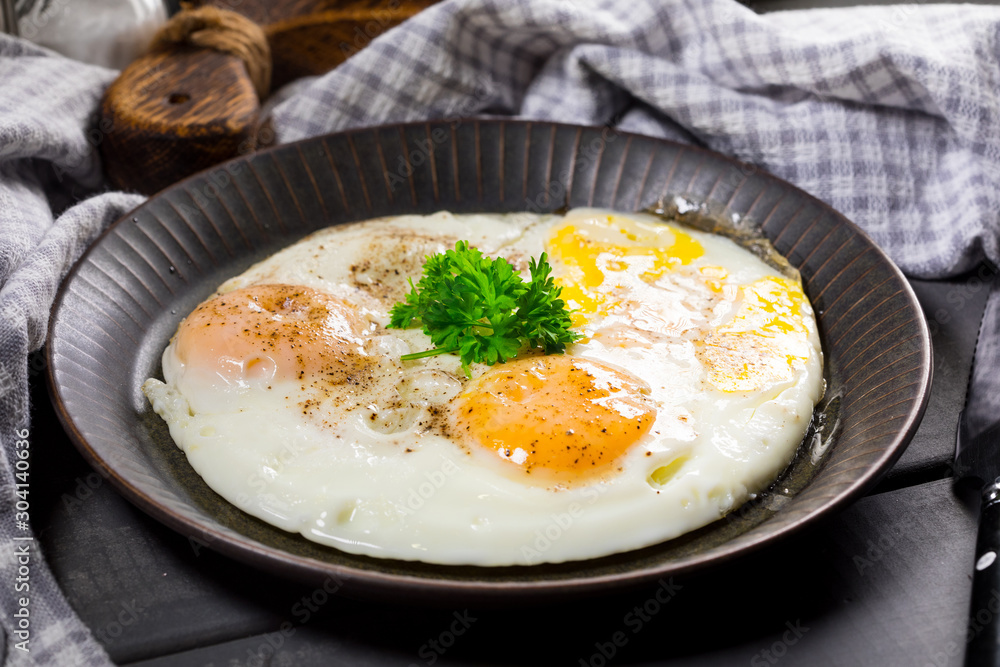 Fried eggs and bread for breakfast on a gray background. Fried eggs and bread for breakfast on a gray background.