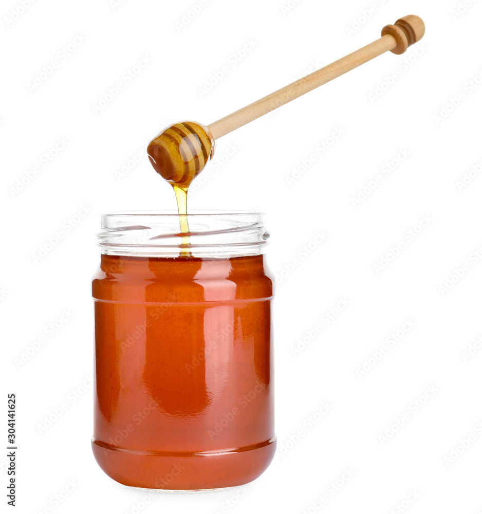 Glass jar of wildflower honey and wooden dipper isolated on white Glass jar of wildflower honey and wooden dipper isolated on white