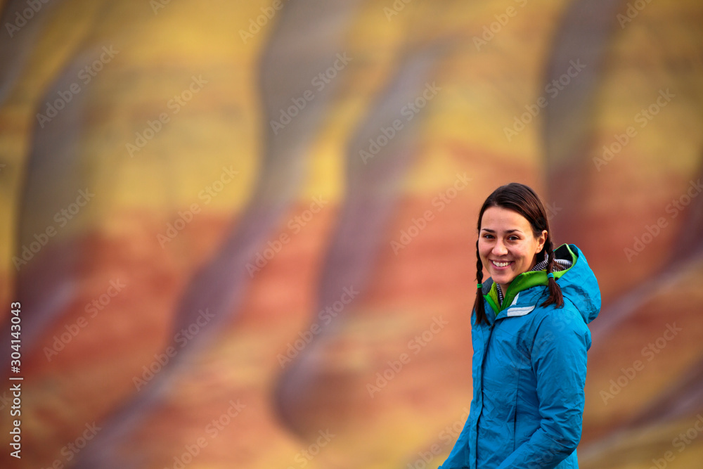 A woman at the overlook near the main parking area at the Painted Hills in the John Day Fossil Beds National Monument in eastern Oregon. A woman at the overlook near the main parking area at the Painted Hills in the John Day Fossil Beds National Monument in eastern Oregon.