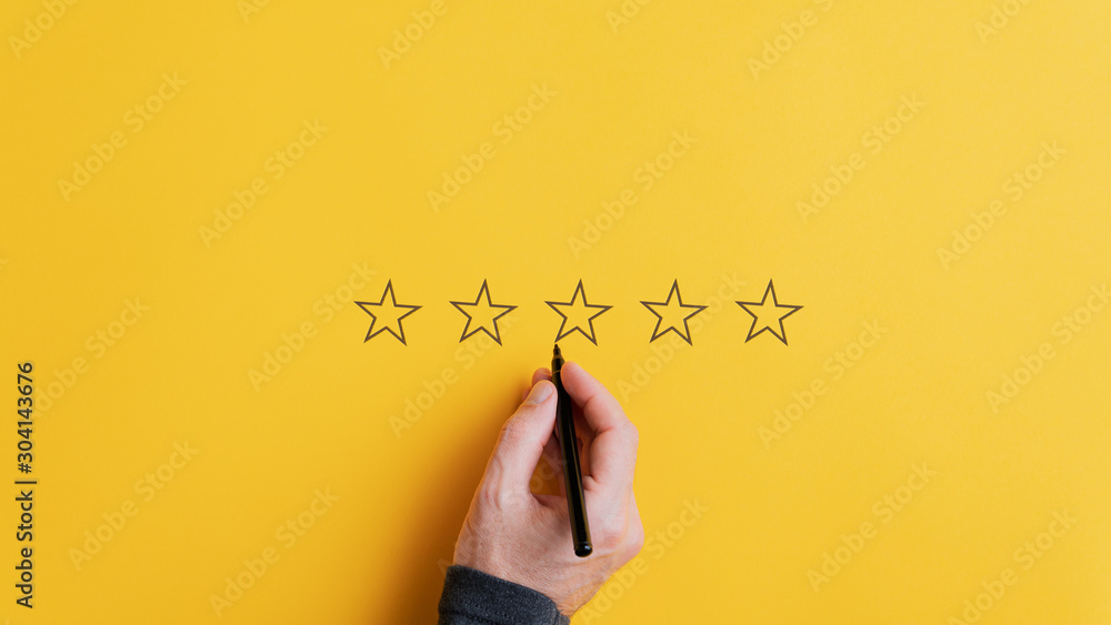 Male hand drawing five stars in a row - obrazy, fototapety, plakaty 