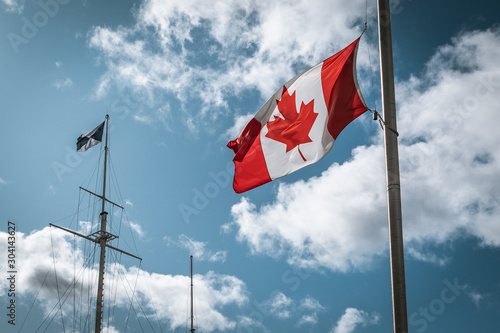 Canadian flag against a blue sky