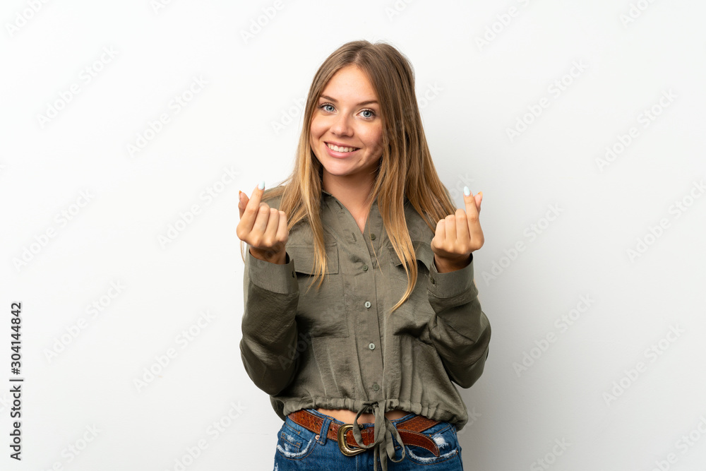 Lithuanian blonde girl over isolated white background making money gesture Lithuanian blonde girl over isolated white background making money gesture