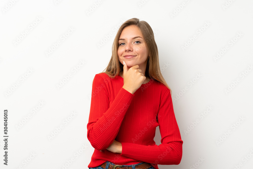Young blonde woman with red sweater over isolated white background laughing Young blonde woman with red sweater over isolated white background laughing