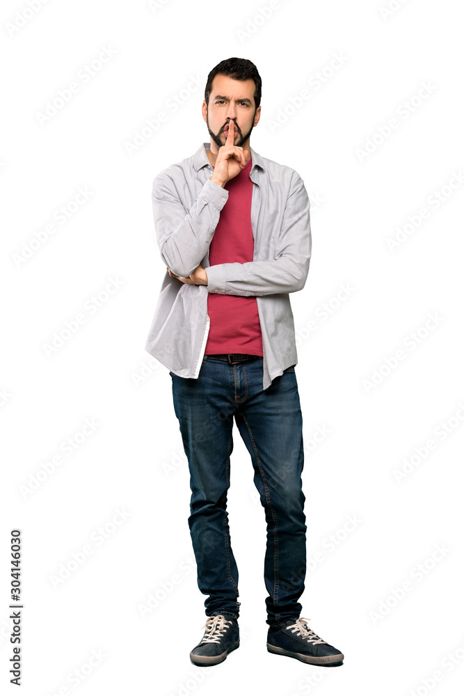 Full-length shot of Handsome man with beard showing a sign of silence gesture putting finger in mouth over isolated white background Full-length shot of Handsome man with beard showing a sign of silence gesture putting finger in mouth over isolated white background