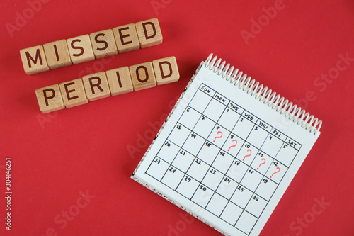 Missed period and marking on calendar. Woman's health and delay in menstruation.