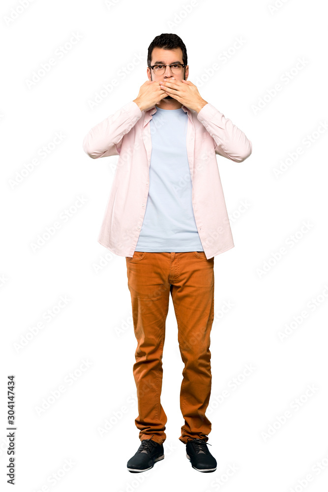 Full-length shot of Handsome man with beard covering mouth with hands over isolated white background Full-length shot of Handsome man with beard covering mouth with hands over isolated white background