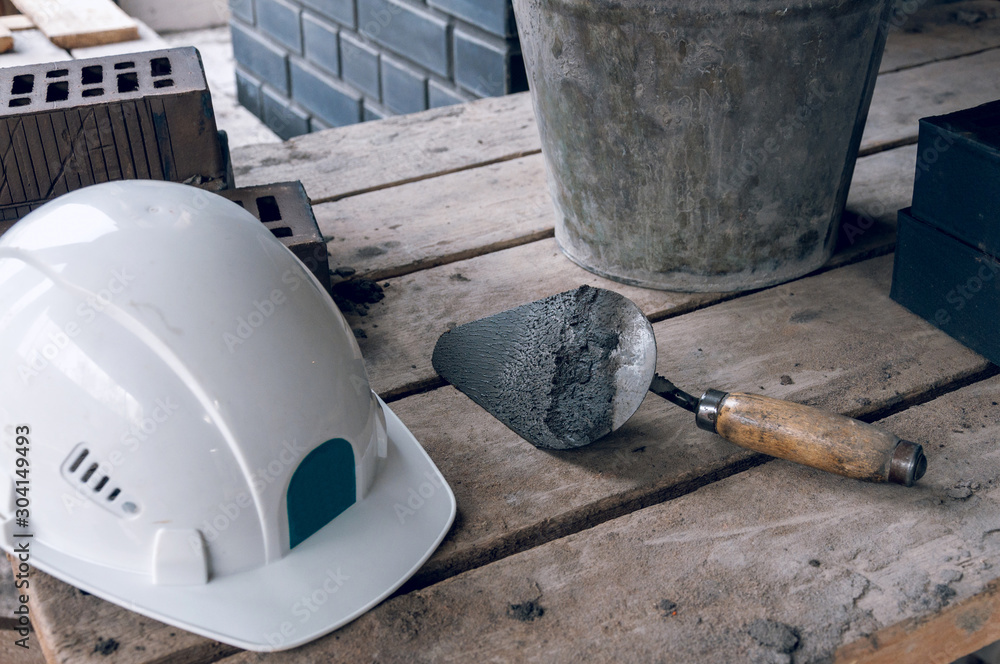 Workplace for a bricklayer close-up. Trowel for bricklaying. Workplace for a bricklayer close-up. Trowel for bricklaying.