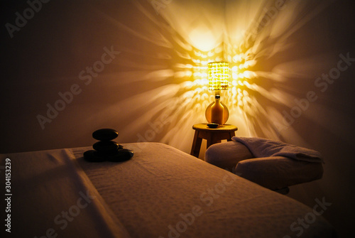 Professional massage relaxation lights and hot stones with coconut oil