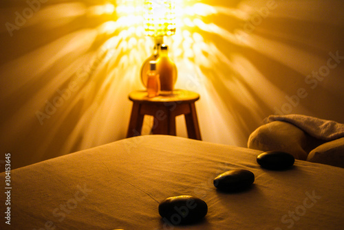 Professional massage relaxation lights and hot stones with coconut oil