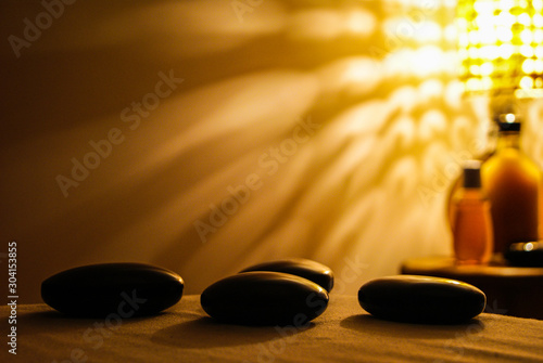 Professional massage relaxation lights and hot stones with coconut oil
