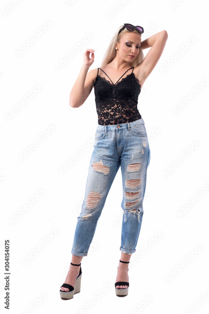 Comfortable relaxed blond hair girl with sunglasses on head posing with raised hand. Full body isolated on white background. Comfortable relaxed blond hair girl with sunglasses on head posing with raised hand. Full body isolated on white background.