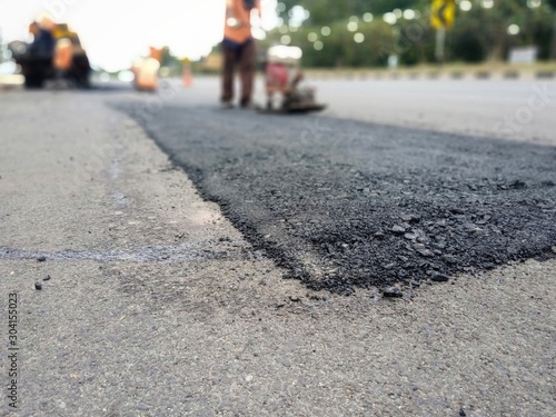 Road surface leveling work With asphalt paving (picture blurred)