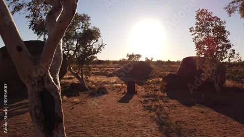 Amazing natural landscapes with deep red color at sunset of Devils Marbles or Karlu Karlu. Gigantic boulders symbol of Australia's outback in Northern Territory, Australia. photo