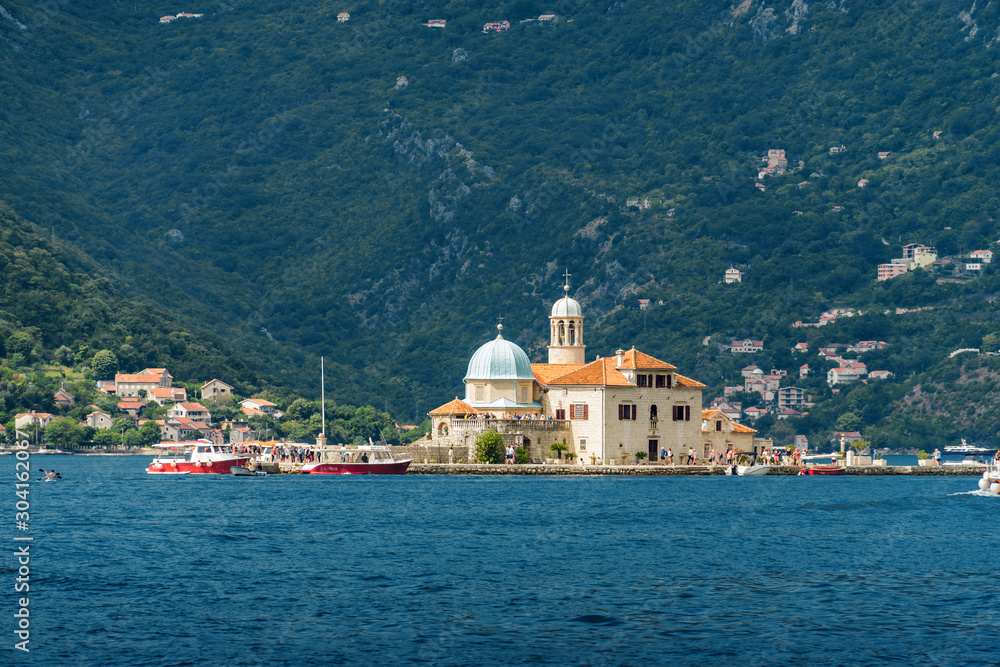 Sunny view of  island of the Lady of the Rocks, Perast, Kotor Bay in Montenegro.