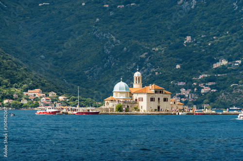 Sunny view of island of the Lady of the Rocks, Perast, Kotor Bay in Montenegro.