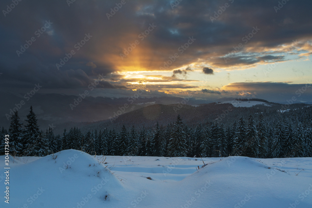 A bright winter in the Ukrainian Carpathian Mountains with snow-capped mountain peaks and picturesque meadows with mountain lodges and hikers. A bright winter in the Ukrainian Carpathian Mountains with snow-capped mountain peaks and picturesque meadows with mountain lodges and hikers.