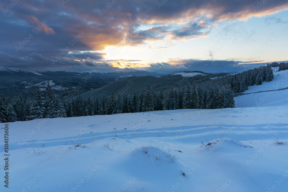 A bright winter in the Ukrainian Carpathian Mountains with snow-capped mountain peaks and picturesque meadows with mountain lodges and hikers. A bright winter in the Ukrainian Carpathian Mountains with snow-capped mountain peaks and picturesque meadows with mountain lodges and hikers.