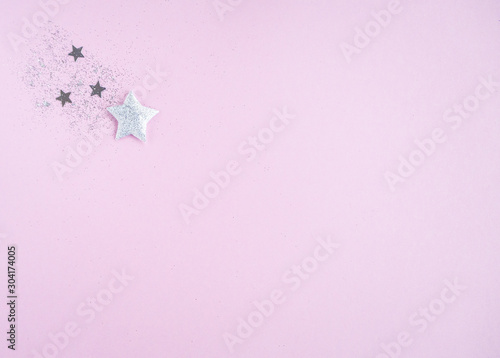 Christmas and New year composition with silver stars on pink background. Flat lay, top view, copy space.  © Tani_Bel