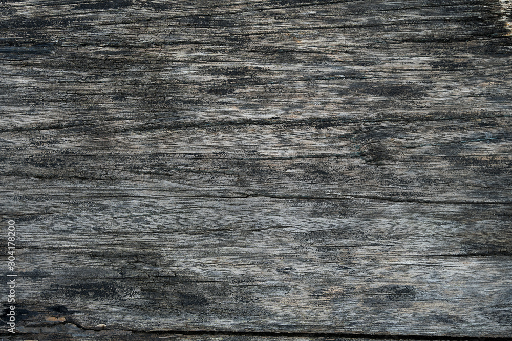 Naklejka premium Black and white monochromatic wooden old board. Cracked, old wooden background. The texture.