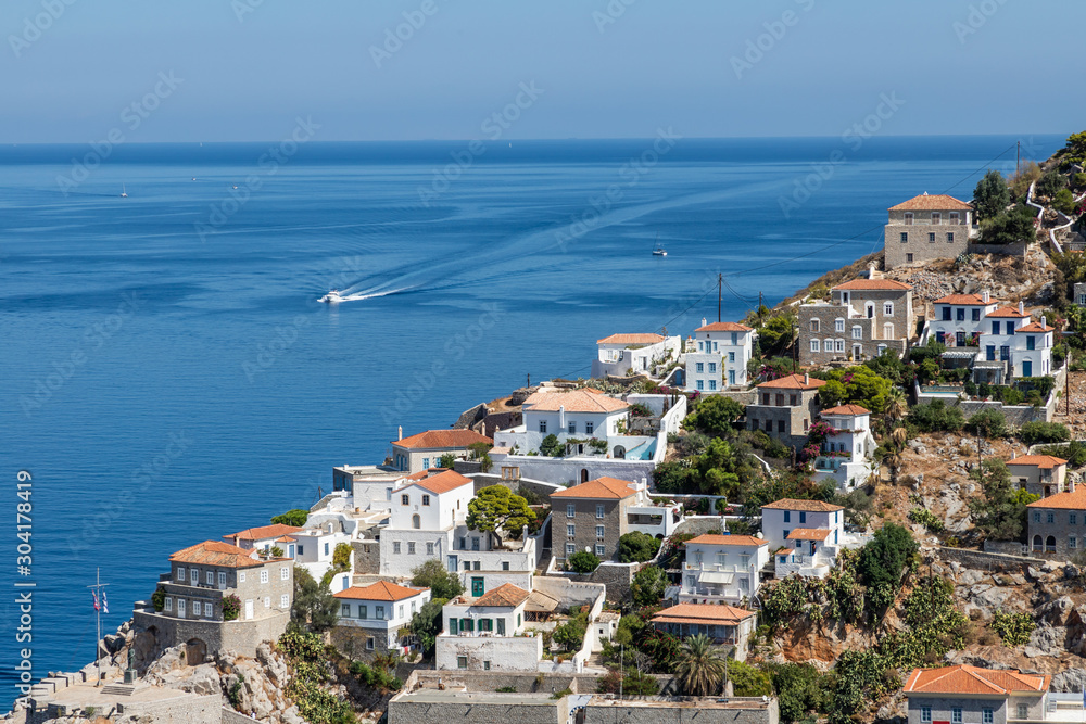 Houses and buildings in the mountains with trees and vegetation in Hydra Island