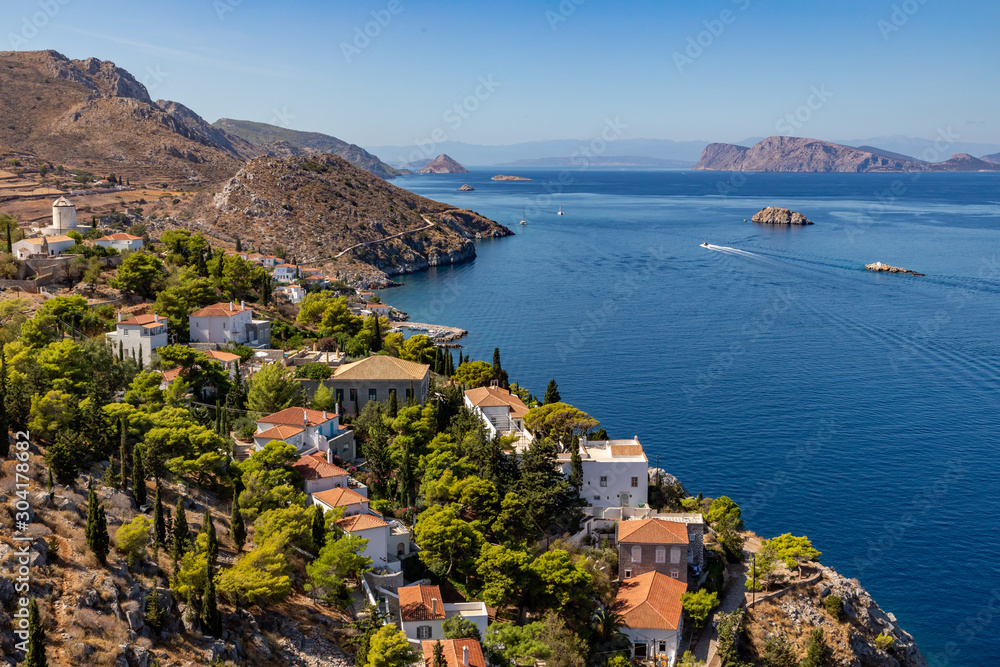 Naklejka premium Houses and buildings in the mountains with trees and vegetation in Hydra Island