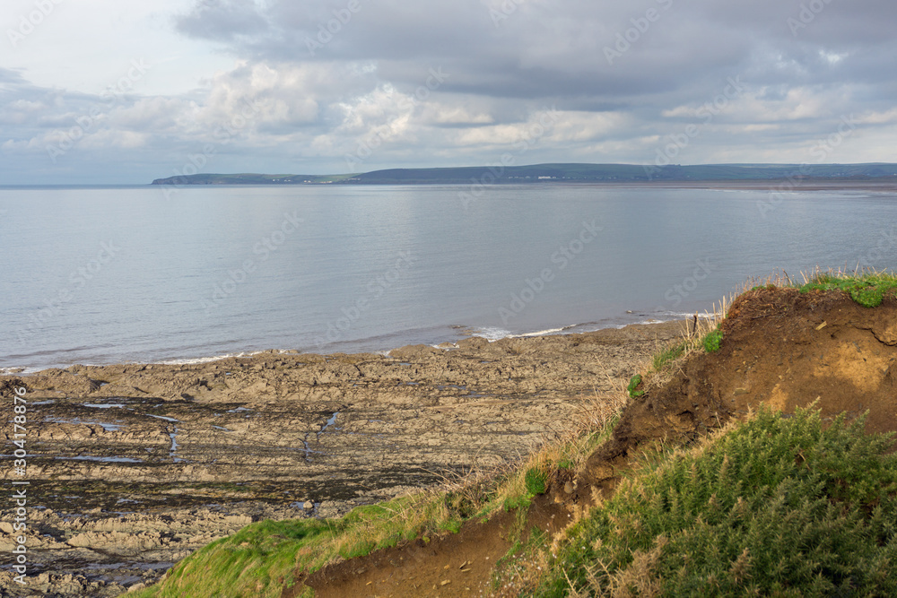 View across Bideford Bay from the Coast path of Westward Ho and Saunton sands on the North Devon coast of England.