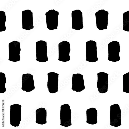 Spotted seamless pattern, hand-drawn. brush strokes black and white, vertical