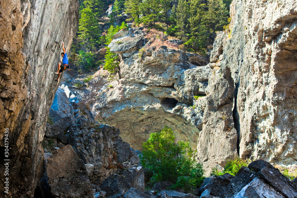 Aman climbs some beatiful limsetone on Monsters of the Deep (5.13c) at Natural Bridges State Park. Aman climbs some beatiful limsetone on Monsters of the Deep (5.13c) at Natural Bridges State Park.