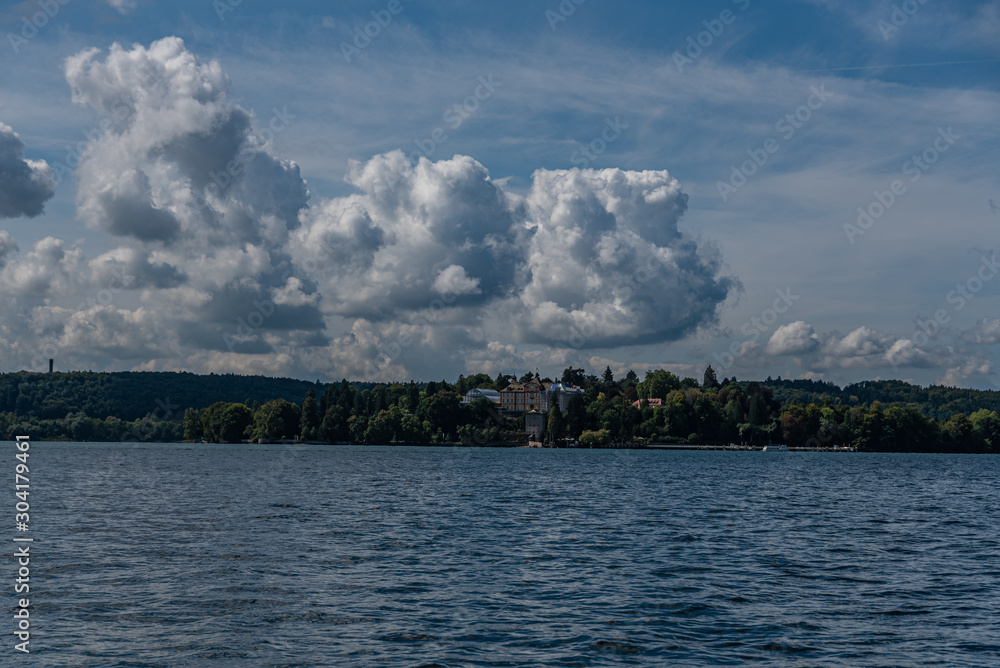 The shoreline at lake constance with clouds in the background