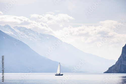 Riva del Garda, Trento, Italy: A sailing boat on lake garda as seen from Riva del Garda.