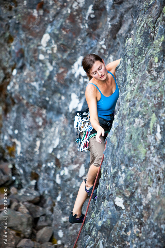 A woman warms up on Noon Time Quickie (5.8) at Deep Creek. A woman warms up on Noon Time Quickie (5.8) at Deep Creek.