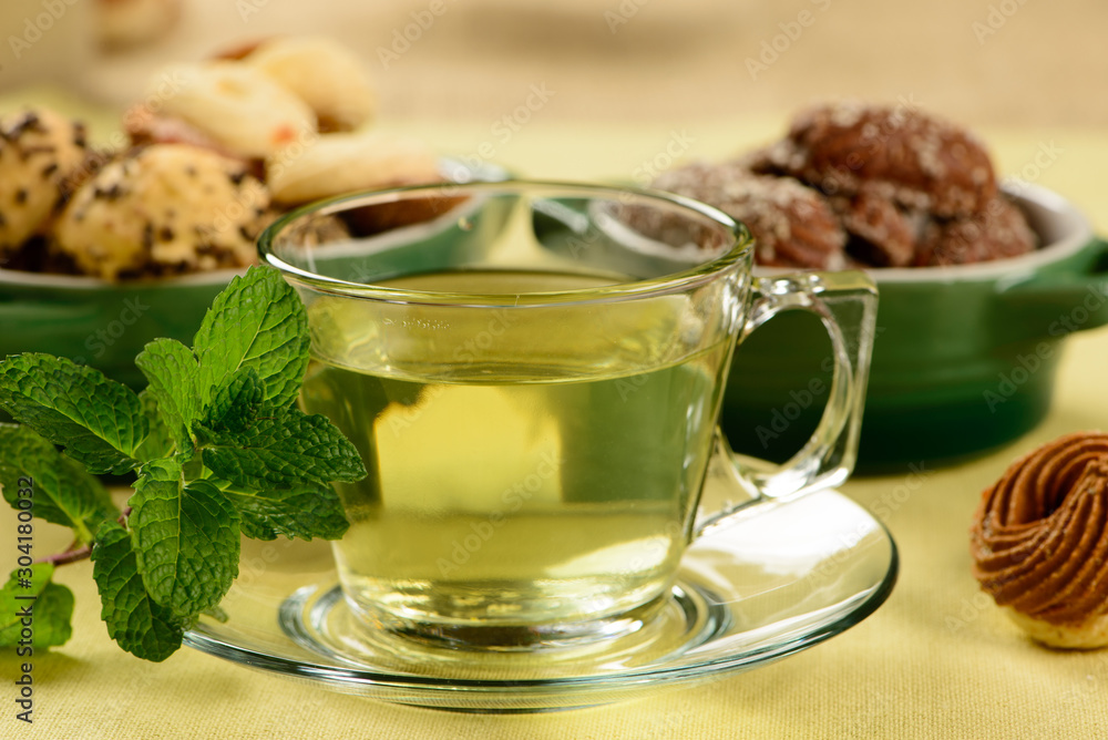 mint tea in transparent cup with sweet cookies around mint tea in transparent cup with sweet cookies around