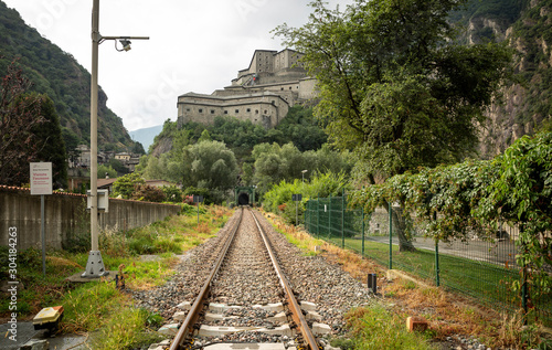 railway in Hone town and a view of the Bard fortress, Aosta Valley, Italy photo