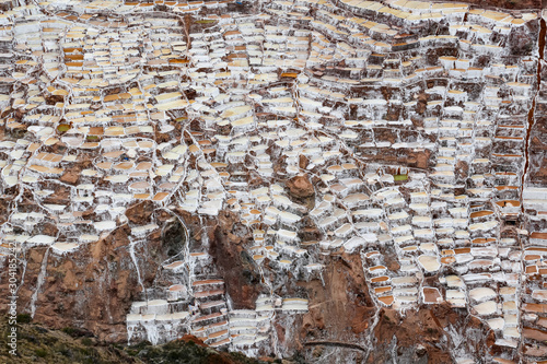 Landscape of the salt terraces of Maras ( Salineras de Maras) in the Andes mountain range in the region of Cusco, Peru, Sacred Valley. One of the main tourist attractions in Cusco Region.